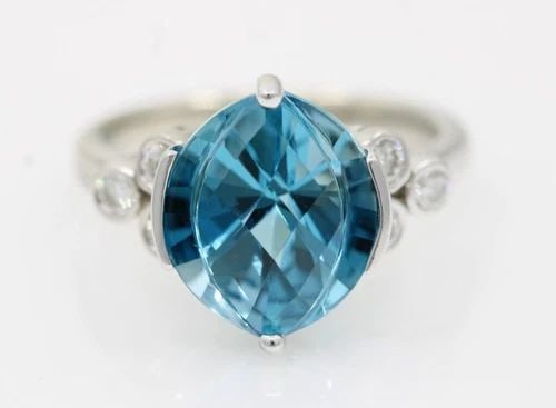 14K WHITE GOLD BLUE TOPAZ & NATURAL DIAMOND RING SIZE 7 - 5.7 GRAMS: 14K WHITE GOLD BLUE TOPAZ & NATURAL DIAMOND RING SIZE 7 - 5.7 GRAMS 14K WHITE GOLD BLUE TOPAZ & NATURAL DIAMOND RING SIZE 7 - 5.7 GRAMS Description 14K White Gold Blue Topaz & Natural Diamond Ring The