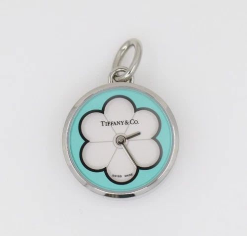 TIFFANY & CO STAINLESS STEEL WHITE BLOSSOM ENAMEL FLOWER DIAL WATCH PENDANT: TIFFANY & CO STAINLESS STEEL WHITE BLOSSOM ENAMEL FLOWER DIAL WATCH PENDANT Description Tiffany & Co Stainless Steel White Blossom Enamel Flower Dial Watch Pendant Pendant/watch is in good condition. 