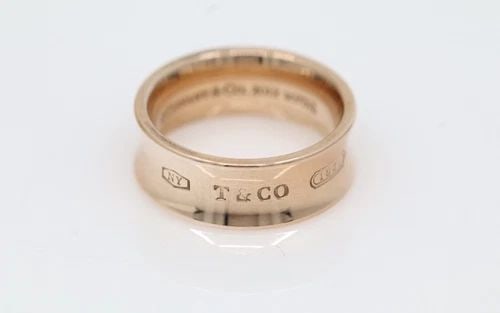TIFFANY & CO. 1837 RUBEDO ROSE TONE 7MM WIDE CONCAVE RING SIZE 5.5: TIFFANY & CO. 1837 RUBEDO ROSE TONE 7MM WIDE CONCAVE RING SIZE 5.5 Description Tiffany & Co. 1837 Rubedo Rose Tone 7mm Concave Ring Ring is in good condition. May show signs of wear and/or tear. Appro