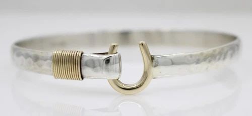 DESIGNER STERLING SILVER & 14K YELLOW GOLD 8MM HOOK BANGLE BRACELET 9" - 33.5 G: DESIGNER STERLING SILVER & 14K YELLOW GOLD 8MM HOOK BANGLE BRACELET 9" - 33.5 G Description Designer Sterling Silver & 14K Yellow Gold Hook Bangle Bracelet Bracelet is in good condition. May show sign