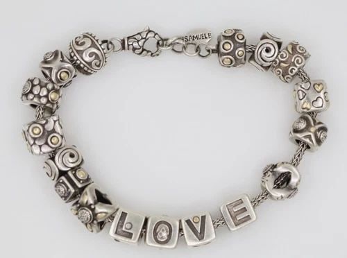 SAMUEL B BENHAM STERLING SILVER & 18K GOLD 17 CHARM BRACELET 7.5" TO 8" ~ 60.2G: SAMUEL B BENHAM STERLING SILVER & 18K GOLD 17 CHARM BRACELET 7.5" TO 8" ~ 60.2G Description Samuel B Benham Sterling Silver & 18K Gold 17 Charm Bracelet Bracelet is in good condition. May show signs o