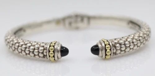 LAGOS CAVIAR STERLING SILVER & 18K YELLOW GOLD ONYX HINGED CUFF BRACELET 7": LAGOS CAVIAR STERLING SILVER & 18K YELLOW GOLD ONYX HINGED CUFF BRACELET 7" Description Lagos Caviar Sterling Silver & 18k Yellow Gold Black Onyx Hinged Cuff Bracelet Bracelet is in good condition. Ma