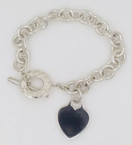 TIFFANY & CO. BLANK ENGRAVABLE HEART TAG TOGGLE CHARM BRACELET 8"- 43.1 GRAMS: TIFFANY & CO. BLANK ENGRAVABLE HEART TAG TOGGLE CHARM BRACELET 8"- 43.1 GRAMS Description Tiffany & Co. Blank Engravable Heart Tag Toggle Charm Bracelet Bracelet is in good condition. May show signs o