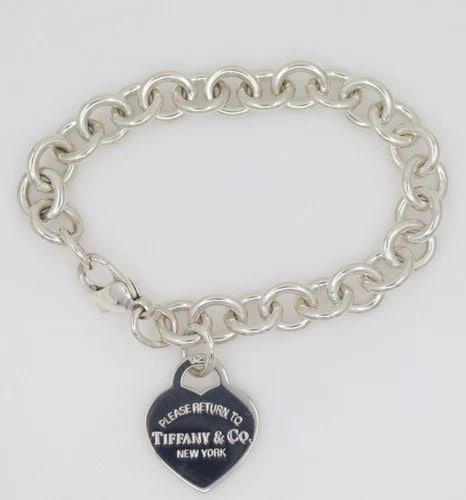 TIFFANY & CO. STERLING SILVER RETURN TO TIFFANY HEART TAG CHARM BRACELET: TIFFANY & CO. STERLING SILVER RETURN TO TIFFANY HEART TAG CHARM BRACELET Description Tiffany & Co. Sterling Silver Return to Tiffany Heart Tag Charm Bracelet Bracelet is in good condition. May show si