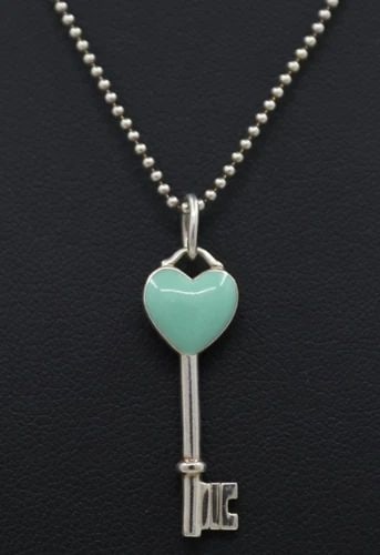 TIFFANY & CO STERLING BLUE ENAMEL HEART KEY CHARM PENDANT CHAIN W/ 16" NECKLACE: TIFFANY & CO STERLING BLUE ENAMEL HEART KEY CHARM PENDANT CHAIN W/ 16" NECKLACE Description Tiffany & Co Sterling Blue Enamel Heart Key Charm Pendant Chain w/ 16" Necklace Pendant/necklace is in good 