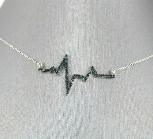 STERLING SILVER 0.33 TCW BLUE DIAMOND HEARTBEAT PENDANT NECKLACE, 3.3 GRAMS: STERLING SILVER 0.33 TCW BLUE DIAMOND HEARTBEAT PENDANT NECKLACE, 3.3 GRAMS STERLING SILVER 0.33 TCW BLUE DIAMOND HEARTBEAT PENDANT NECKLACE, 3.3 GRAMS Description Sterling Silver 0.33 TCW Blue Diamon