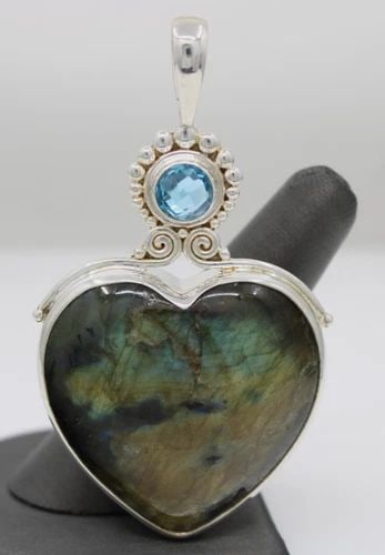 SAJEN STERLING SILVER LABRADORITE HEART & BLUE TOPAZ PENDANT: SAJEN STERLING SILVER LABRADORITE HEART & BLUE TOPAZ PENDANT Description Sajen Sterling Silver Labradorite Heart & Blue Topaz Pendant Pendant is in good condition. May show signs of wear and/or tear. 