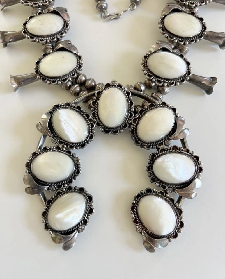 HUGE VTG NAVAJO STERLING SILVER MOTHER OF PEARL SQUASH BLOSSOM NECKLACE 279.6G: MASSIVE Vtg Navajo Sterling Silver Mother Of Pearl Squash Blossom Necklace 279.6g This Amazing necklace features huge specimens Natural Mother Of Pearl, secure in a Smooth bezel. Necklace has Handmade