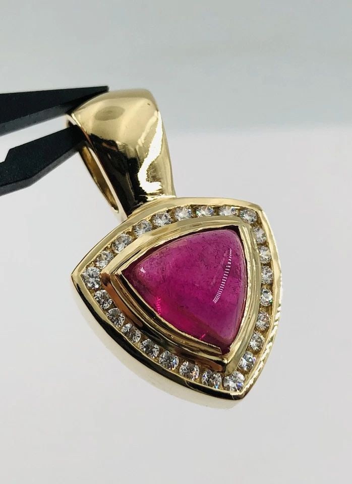 14K YELLOW GOLD CABOCHON NATURAL RUBELLITE TOURMALINE & WHITE SAPPHIRE PENDANT: 14K YELLOW GOLD CABOCHON NATURAL RUBELLITE TOURMALINE & WHITE SAPPHIRE PENDANT 14k Yellow Gold Cabochon Natural Rubellite Tourmaline & White Sapphire Pendant Size: Over 1 1/4" Tall By 3/4" Wide Weight