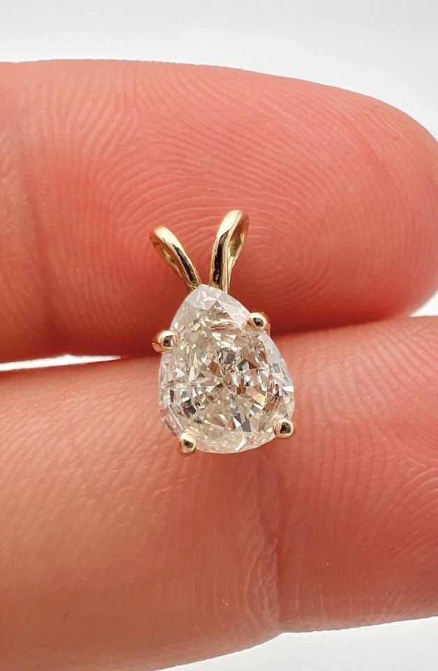 FINE 14K YELLOW GOLD NATURAL PEAR SHAPED .75CT APPROX. DIAMOND SOLITAIRE PENDANT: FINE 14K YELLOW GOLD NATURAL PEAR SHAPED .75CT APPROX. DIAMOND SOLITAIRE PENDANT Fine 14k Yellow Gold Natural Pear Shaped .75ct Approx. Diamond Solitaire Pendant Size: 11mm Tall By 6mm Wide Metal: 14k