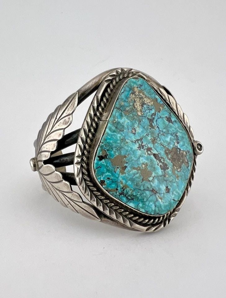 VINTAGE NAVAJO STERLING SILVER HIGH GRADE MORENCI TURQUOISE CUFF BRACELET 88.7G: HEAVY Vintage Navajo Sterling Silver High Grade Morenci Turquoise Cuff Bracelet 88.7g Cuff is 5 1/8" tip to Tip and has a 7/8" Wide Slightly Adjustable Gap Cuff Is 2 1/4" Wide In the Center Weight is 