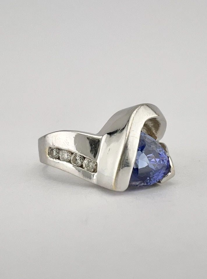 DESIGNER 14K WHITE GOLD TRILLION CUT TANZANITE & DIAMOND BYPASS RING: DESIGNER 14K WHITE GOLD TRILLION CUT TANZANITE & DIAMOND BYPASS RING Designer 14k White Gold Trillion Cut Tanzanite & Diamond Bypass Ring Size: 4.25 - Can Be Resized Weight is 5.3 Grams on my scale Me