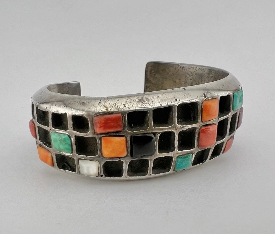 RARE 116G UNUSUAL NAVAJO SANDCAST STERLING SILVER MULTI GEMSTONE CUFF BRACELET: RARE 116G UNUSUAL NAVAJO SANDCAST STERLING SILVER MULTI GEMSTONE CUFF BRACELET Rare 116g Unusual Navajo Sandcast Sterling Silver Multi Gemstone Cuff Bracelet Cuff is 4 1/2" tip to Tip and has a 1 1/2"