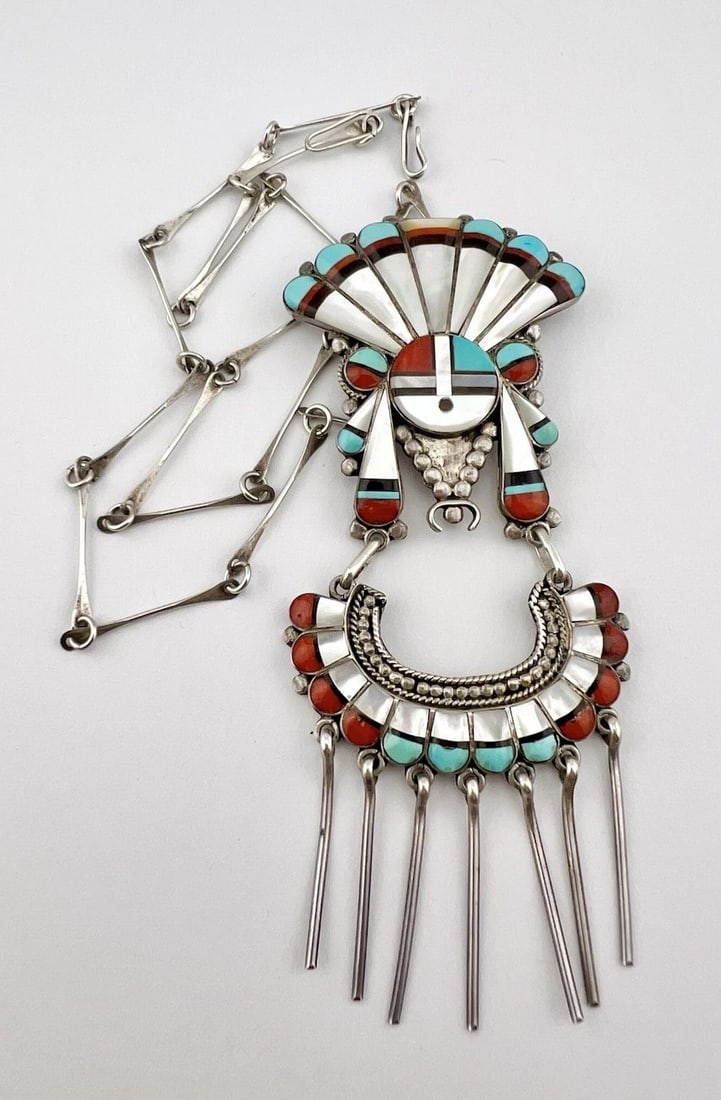 VERDEL & ESTHER NIIHA ZUNI ZUNI STERLING SILVER SUNFACE DANGLE PENDANT NECKLACE: Vintage Verdel & Esther Niiha Zuni Zuni Sterling Silver Sunface Dangle Pendant Necklace MEASUREMENTS: Necklace measures 23" tip To tip - Adjustable In Size Pendant Size: is 4 3/4" Tall With Dangle By 