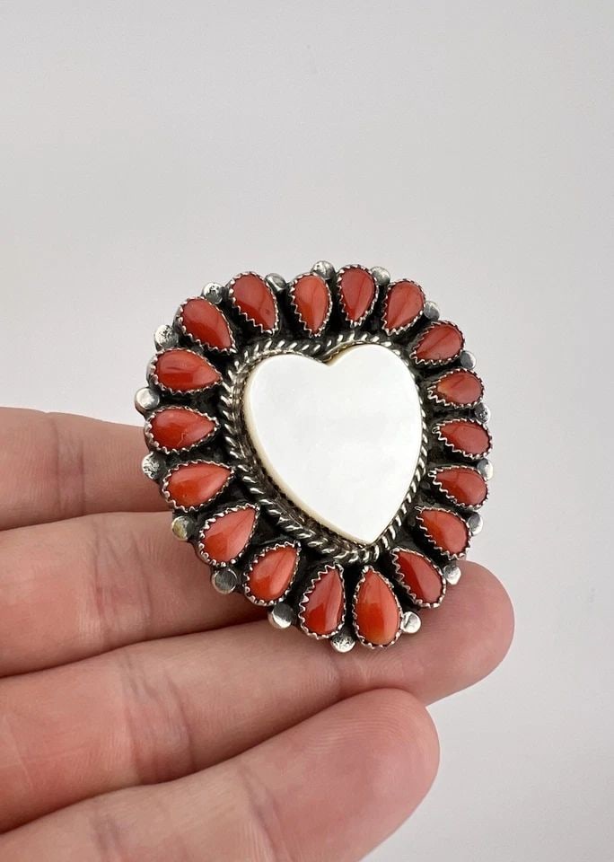 EDNEI YABENY NAVAJO STERLING SILVER CORAL & MOTHER OF PEARL CLUSTER HEART RING: Ednei Yabeny Navajo Sterling Silver Coral & Mother of Pearl Cluster Heart Ring Ring Size: 9.5 - Adjustable In Size Weight is 34.0 Grams on my scale Metal: Sterling Silver Face of The Ring is 2" Tall I