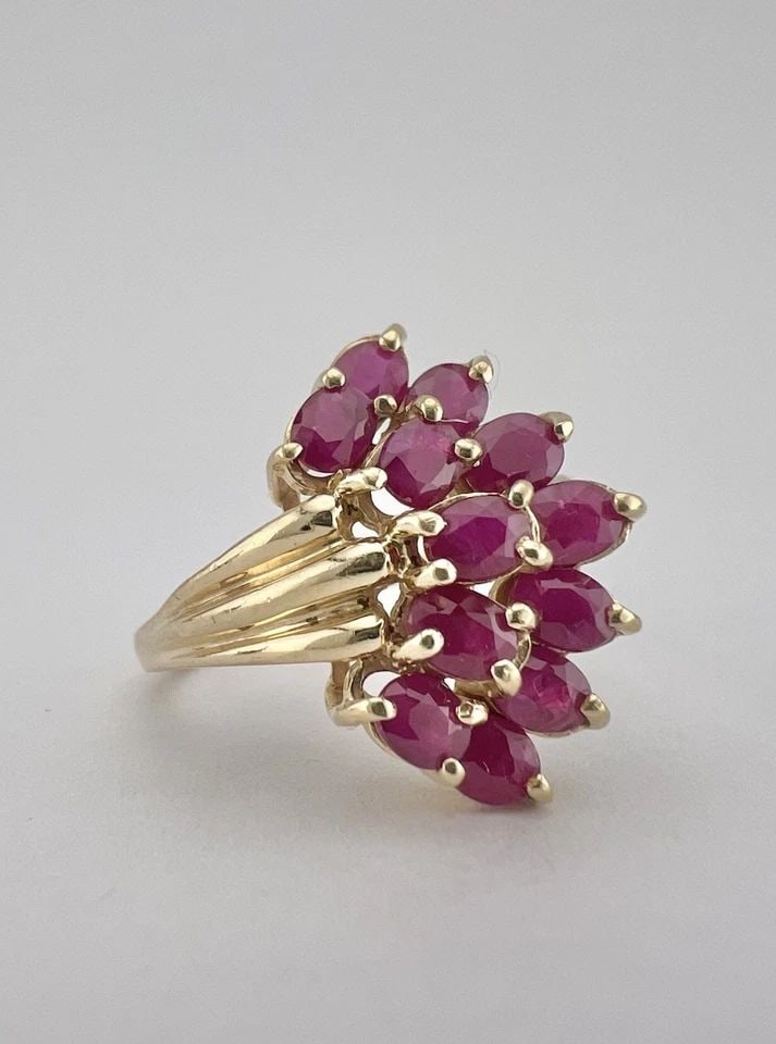 DESIGNER 10K YELLOW GOLD NATURAL MARQUIESE CUT RUBY CLUSTER RING: Designer 10k Yellow Gold Natural Marquiese Cut Ruby Cluster Ring Ring Size: 8.5 - Can Be Resized Metal: 10k Yellow Gold - Tested & Hallmarked Weight is 5.1 Grams on my scale Ring is 7/8" (20mm) Wide I