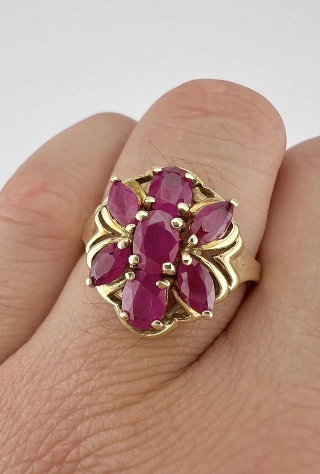 DESIGNER 10K YELLOW GOLD NATURAL RUBY CLUSTER RING: DESIGNER 10K YELLOW GOLD NATURAL RUBY CLUSTER RING Designer 10k Yellow Gold Natural Ruby Cluster Ring Ring Size: 10.25 - Can Be Resized Metal: 10k Yellow Gold - Tested & Hallmarked Weight is 4.6 Grams