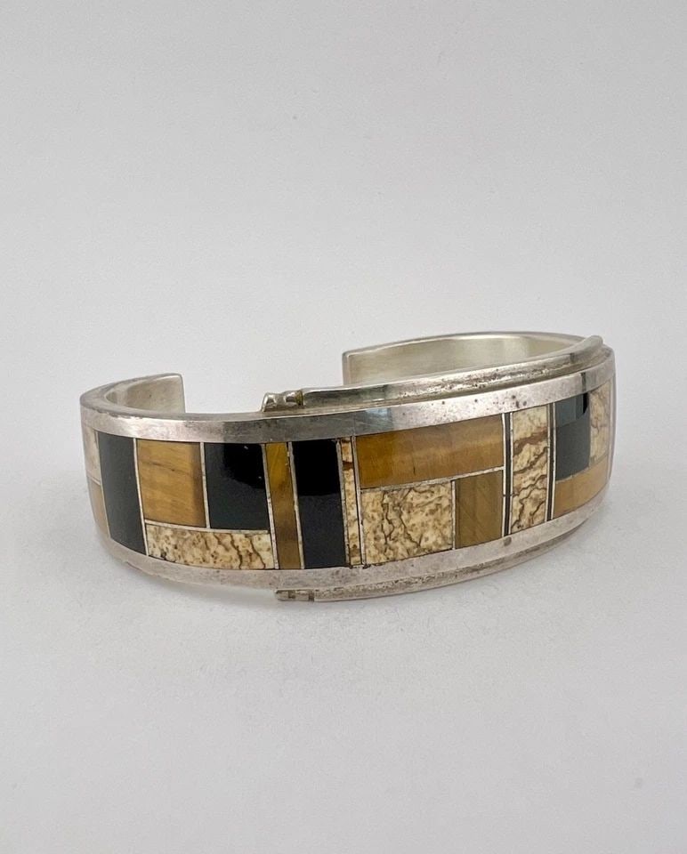 DONNY & DOROTHY CLARK STERLING SILVER MULTI GEMSTONE FLUSH INLAY CUFF BRACELET: DONNY & DOROTHY CLARK STERLING SILVER MULTI GEMSTONE FLUSH INLAY CUFF BRACELET Vtg Donny & Dorothy Clark Sterling Silver Multi Gemstone Flush Inlay Cuff Bracelet Cuff is 5 1/2" tip to Tip and has a 1 