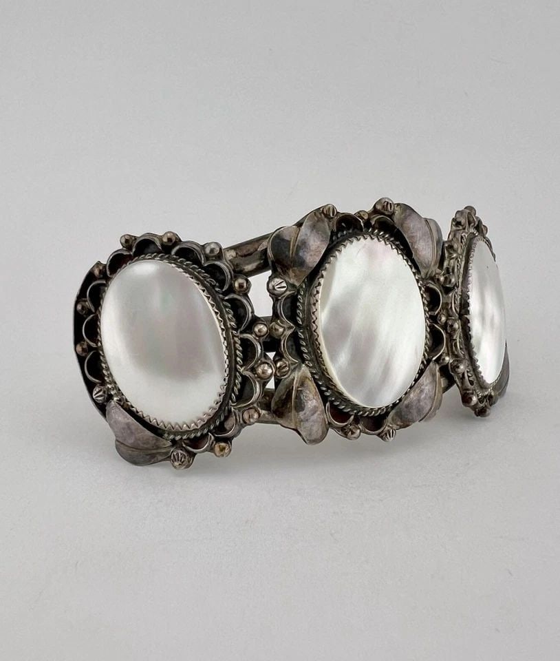 HUGE VINTAGE NAVAJO STERLING SILVER MOTHER OF PEARL STAMPED CUFF BRACELET 72.3G: HUGE Vintage Navajo Sterling Silver Mother of Pearl Stamped Cuff Bracelet 72.3g Cuff is A Tad over 5" tip to Tip and has a 1 1/8" Wide Slightly Adjustable Gap Cuff Is 1 1/2" Wide In The Center Total W