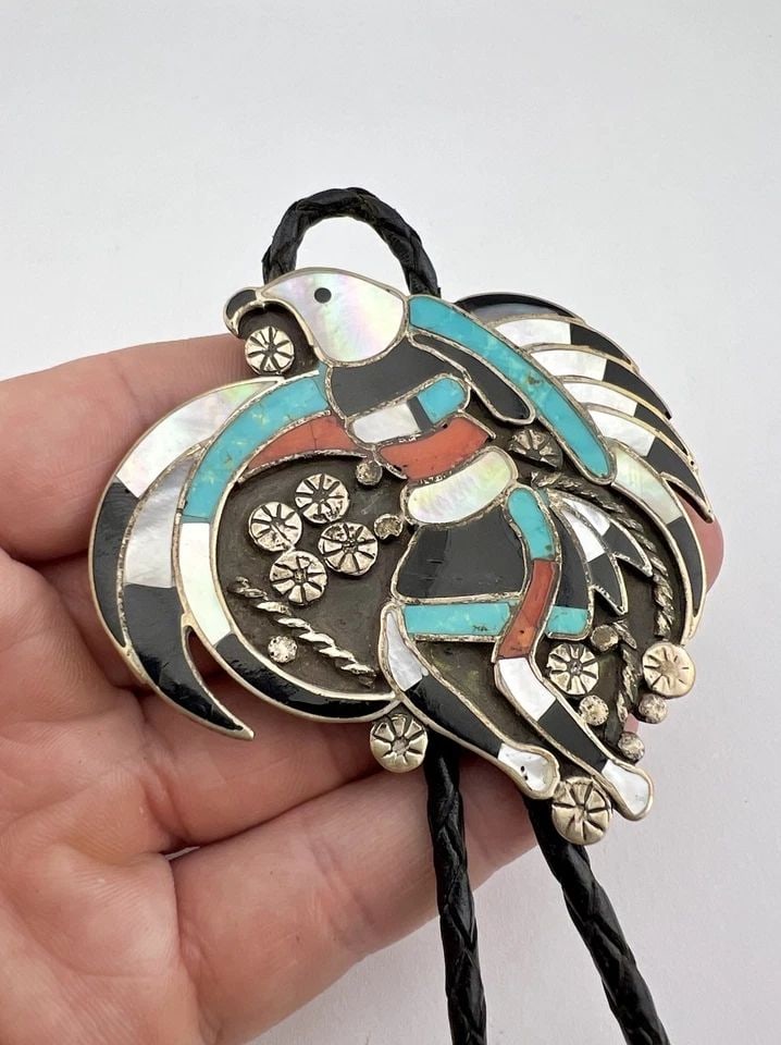 VINTAGE JOHN LUCIO? ZUNI STERLING SILVER FLUSH INLAY EAGLE DANCER BOLO TIE 2.75": Vintage John Lucio? Zuni Sterling Silver Flush Inlay Eagle Dancer Bolo Tie 2 7/8" Size: 2 7/8" Tall by 2 3/4" Wide Weight is 50.5 Grams on my scale Metal: Sterling Silver Amazing Natural Turquoise, Co
