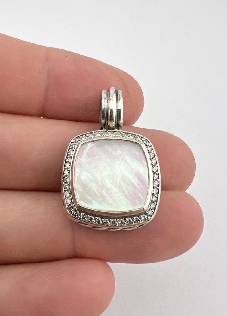 DAVID YURMAN ALBION STERLING SILVER MOTHER OF PEARL & DIAMOND ENHANCER PENDANT: David Yurman Albion Sterling Silver Mother Of Pearl & Diamond Enhancer Pendant Size: 1 1/4" Tall With Bail by 3/4" (20mm) Wide Weight is 9.7 Grams on my scale Metal: Sterling Silver Amazing Natural Mo