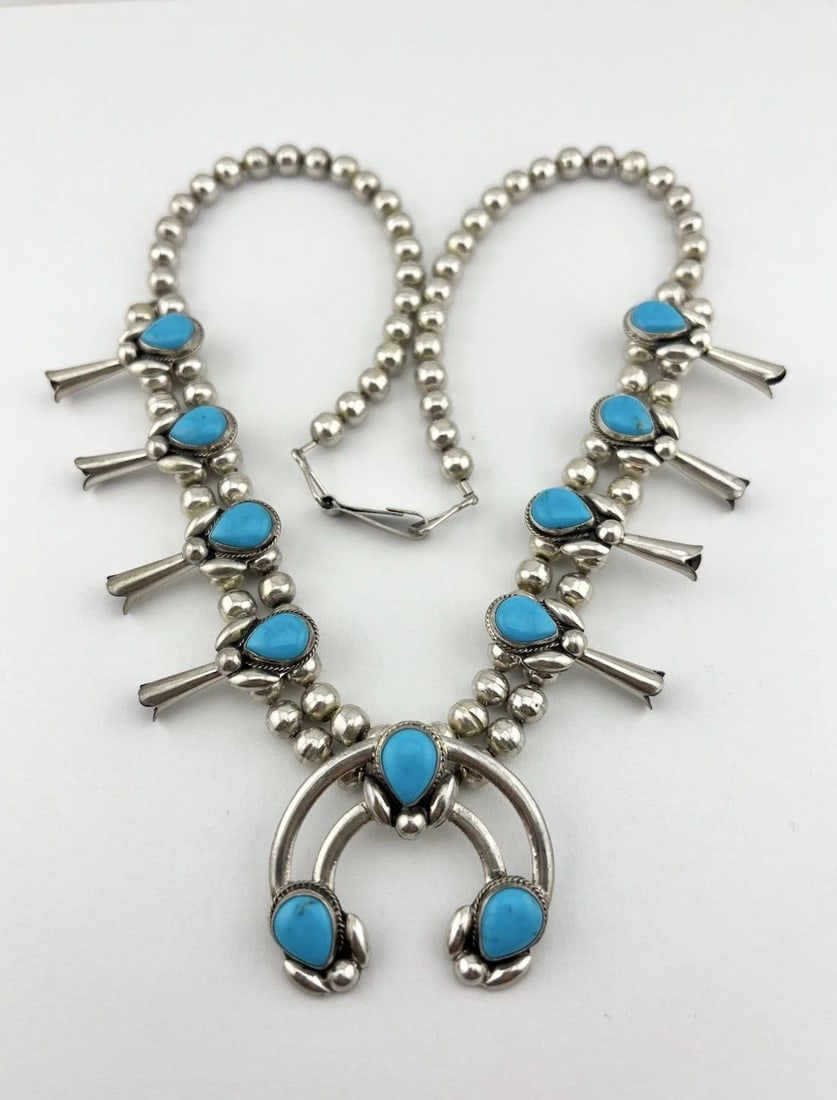 VTG NAVAJO STERLING SILVER BLUE TURQUOISE SQUASH BLOSSOM NECKLACE 21.25" - 59.5G: Vtg Navajo Sterling Silver Blue Turquoise Squash Blossom Necklace 21.25" - 59.5g This Amazing necklace features huge specimens of Blue Turquoise, secure in a Smooth bezel. Necklace has 6mm Wide bench 