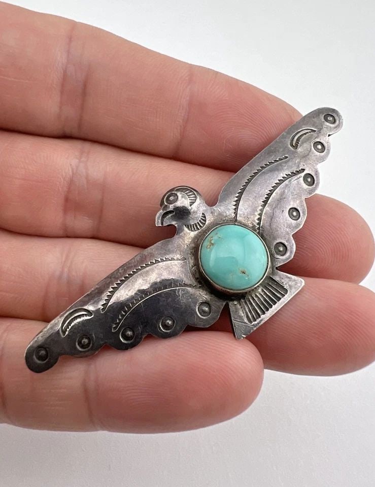 OLD UITA-36 NAVAJO STERLING SILVER TURQUOISE STAMPED THUNDERBIRD PIN BROOCH 2.5": Old UITA-36 Navajo Sterling Silver Turquoise Stamped Thunderbird Pin Brooch 2.5" Size: 2 1/2" Wide By 1" Tall Metal: Sterling Silver / Coin Silver Weight is 6.8 Grams on my scale In Great Antique Cond