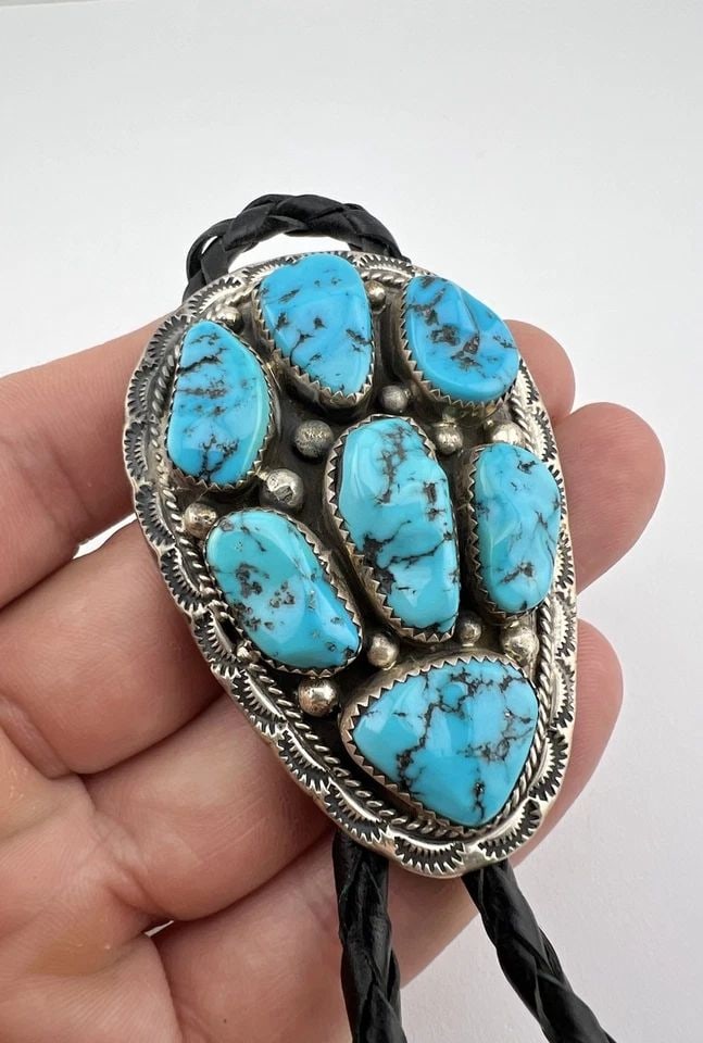 VTG NAVAJO STERLING SILVER SLEEPING BEAUTY TURQUOISE CLUSTER STAMPED BOLO TIE: VTG NAVAJO STERLING SILVER SLEEPING BEAUTY TURQUOISE CLUSTER STAMPED BOLO TIE Vtg Navajo Sterling Silver Sleeping Beauty Turquoise Cluster Stamped Bolo Tie Size: 2 1/2" Tall by 1 3/4" Wide Weight is 4