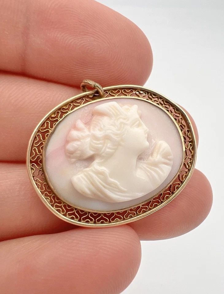 ANTIQUE VICTORIAN 10K YELLOW GOLD CARVED CORAL CAMEO FILIGREE PENDANT: ANTIQUE VICTORIAN 10K YELLOW GOLD CARVED CORAL CAMEO FILIGREE PENDANT Antique Victorian 10k Yellow Gold Carved Coral Cameo Filigree Pendant Size: 1 1/8" Tall With Bail By 1 1/4" Wide Weight is 4.9 Gra