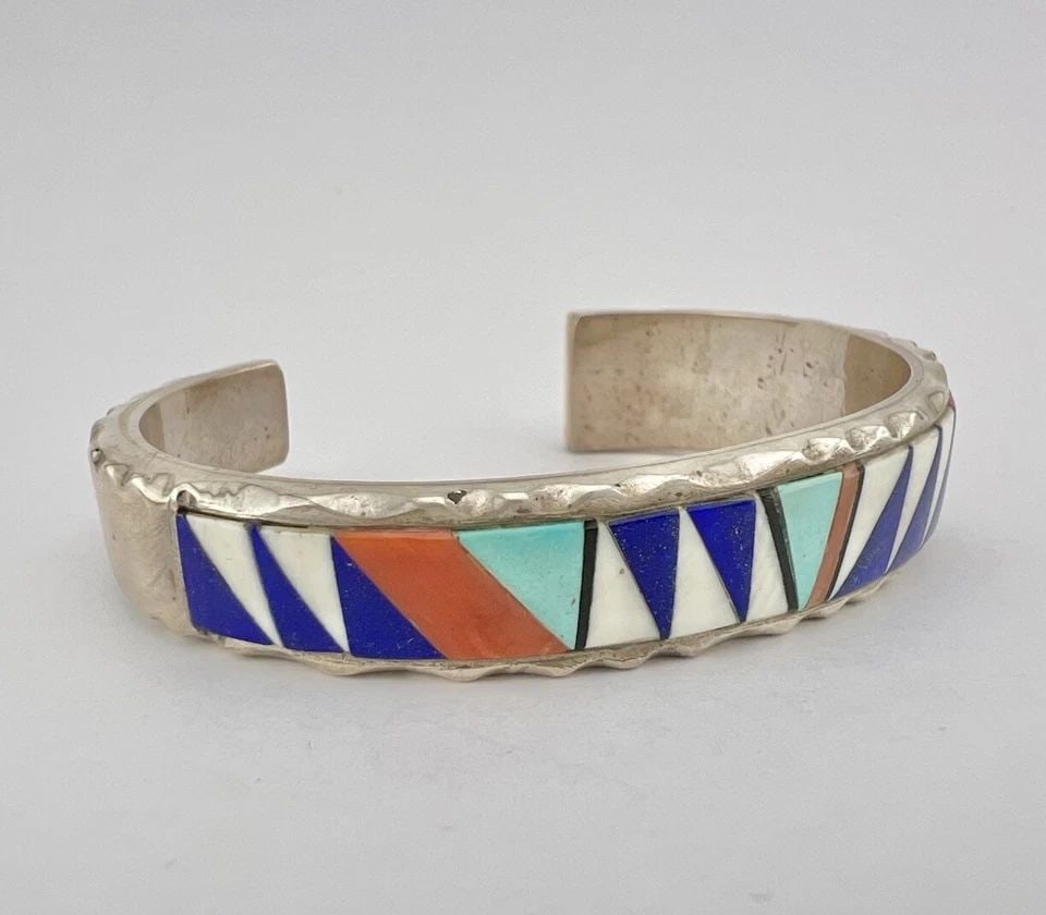 VTG RICK TOLINO NAVAJO STERLING SILVER MULTI GEMSTONE FLUSH INLAY CUFF BRACELET: VTG RICK TOLINO NAVAJO STERLING SILVER MULTI GEMSTONE FLUSH INLAY CUFF BRACELET Vtg Rick Tolino Navajo Sterling Silver Multi Gemstone Flush Inlay Cuff Bracelet Cuff is 5 1/8" tip to Tip and has a 1 1/