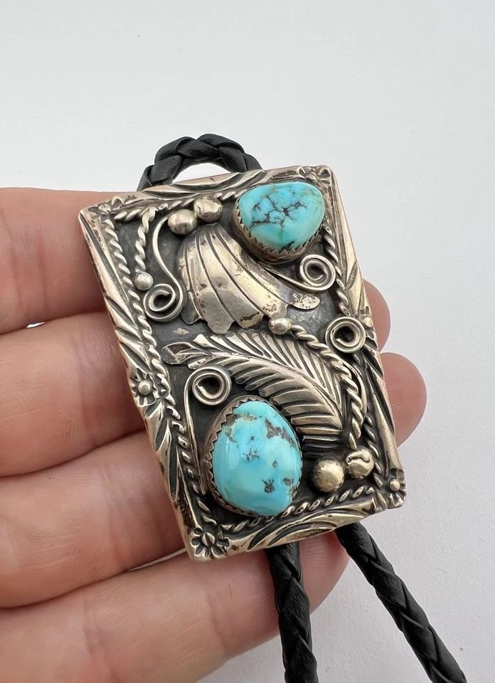 VTG W. DODSON NAVAJO STERLING SILVER SLEEPING BEAUTY TURQUOISE STAMPED BOLO TIE: VTG W. DODSON NAVAJO STERLING SILVER SLEEPING BEAUTY TURQUOISE STAMPED BOLO TIE Vtg W. Dodson Navajo Sterling Silver Sleeping Beauty Turquoise Stamped Bolo Tie Size: 2 1/8" Tall by 1 5/8" Wide Weight 