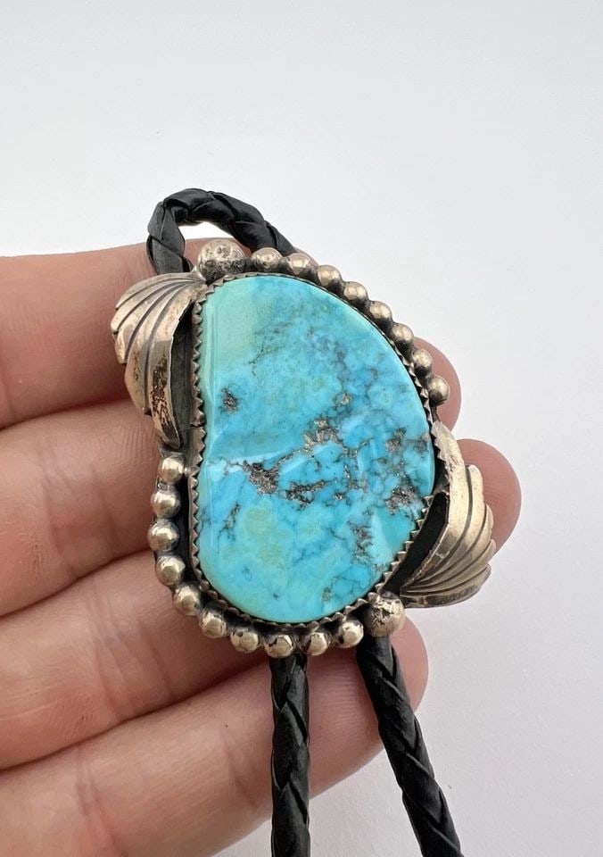VTG NAVAJO STERLING SILVER HIGH-GRADE SLEEPING BEAUTY TURQUOISE STAMPED BOLO TIE: VTG NAVAJO STERLING SILVER HIGH-GRADE SLEEPING BEAUTY TURQUOISE STAMPED BOLO TIE Vtg Navajo Sterling Silver High-Grade Sleeping Beauty Turquoise Stamped Bolo Tie Size: 1 3/4" Tall by 1 3/8" Wide Weigh