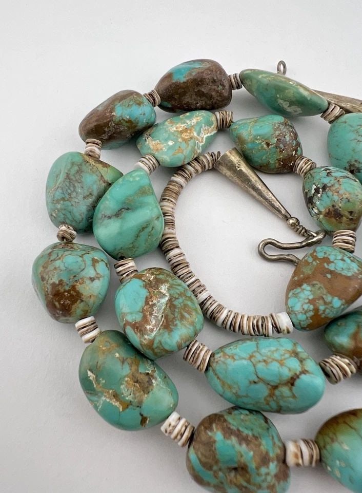 SANTO DOMINGO KEWA KING'S MANASSA TURQUOISE & OLIVE SEHLL HEISHI NECKLACE 27.5": Vintage Santo Domingo Kewa king's Manassa Turquoise & Olive Sehll Heishi Necklace 27.5" The Turquoise Stones are From 15mm to 20mm Wide Necklace Is 1 Massive Strands Total weight is 113.6 Grams on my 