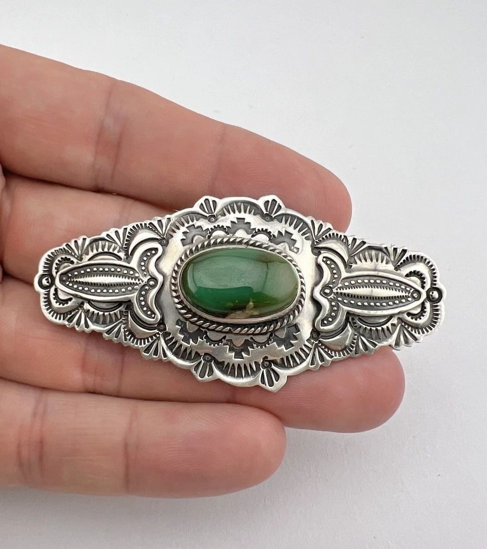 JOHN DELVIN NAVAJO STERLING SILVER PILOT MOUNTAIN TURQUOISE PIN BROOCH 2.75": Vintage John Delvin Navajo Sterling Silver Pilot Mountain Turquoise Pin Brooch 2.75" Size: 1 1/4" Tall by 2 3/4" Wide Metal: Sterling Silver Weight is 19.5 Grams on my scale Amazing Natural High Grade