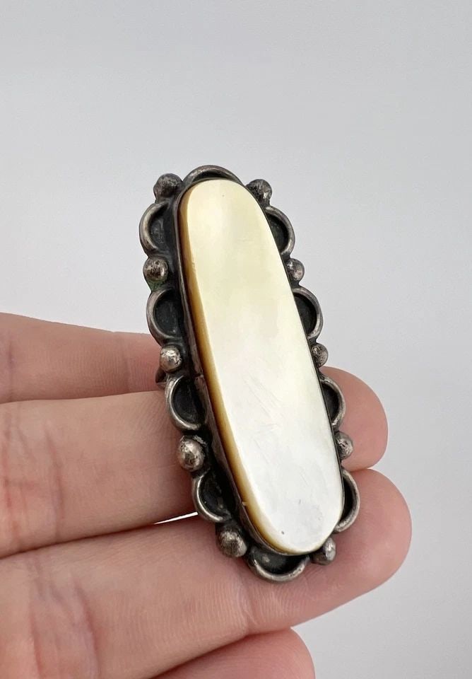 VINTAGE NAVAJO STERLING SILVER MOTHER OF PEARL STAMPED 2.25" LONG RING 20G: Vintage Navajo Sterling Silver Mother Of Pearl Stamped 2.25" Long Ring Ring Size: 5.75 - Can Be Re Sized Weight is 20.00 Grams on my scale Metal: Sterling Silver Ring is 2 1/4" Tall In the Center Amaz