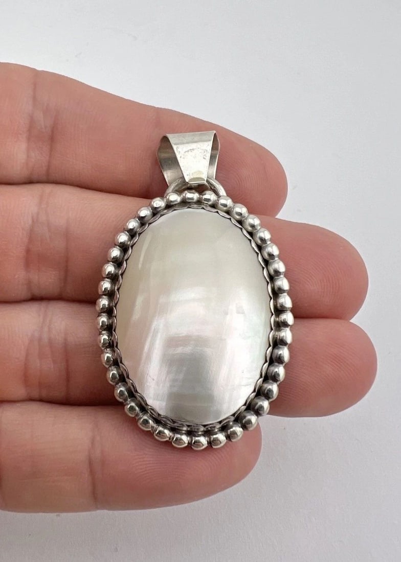VINTAGE WILLIAM G. JOHNSON NAVAJO STERLING SILVER MOTHER OF PEARL PENDANT 2": Vintage William G. Johnson Navajo Sterling Silver Mother of Pearl Pendant 2" Size: 2" Tall With Bail & Just Under 1 1/4" Wide Weight is 16.0 Grams on my scale Test Positive For Sterling Silver Amazing