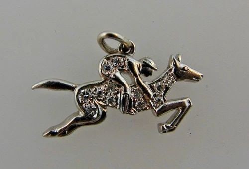 ART DECO PLATINUM & DIAMOND EQUESTRIAN CHARM CIRCA 1920S: ART DECO PLATINUM & DIAMOND EQUESTRIAN CHARM CIRCA 1920S Platinum & Diamond Equestrian Charm Art Deco This is a must for a collector. The weight is 2 grams. The height with bail is 5/8 of an inch. The