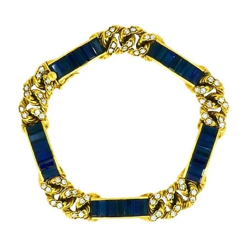 VINTAGE FRED PARIS BRACELET SAPPHIRE DIAMOND 18K GOLD ESTATE JEWELRY: HEMMERLE 18 karat Yellow Gold Sapphire Leather Spiral Bracelet A vintage Fred Paris bracelet with sapphires and diamonds, crafted in 18k gold. The bracelet features sleek baguette cut blue sapphires, 