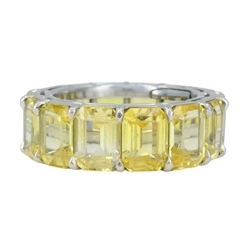 BVLGARI YELLOW SAPPHIRE PLATINUM ETERNITY BAND BULGARI RING: BVLGARI YELLOW SAPPHIRE PLATINUM ETERNITY BAND BULGARI RING This vintage Bvlgari eternity ring from the 1980s is crafted in platinum and set with a continuous row of emerald-cut yellow sapphires. The 