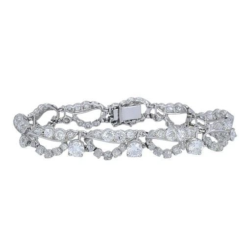 FRENCH PLATINUM DIAMOND OPENWORK DIAMOND BRACELET, 1960S: FRENCH PLATINUM DIAMOND OPENWORK DIAMOND BRACELET, 1960S MATERIALS Platinum GEMSTONE Diamond WEIGHT 25.7 Grams MEASUREMENTS 6 1/2" x 3/8" HALLMARKS Maker's Mark ITEM DETAILS Art Deco Platinum Diamond 