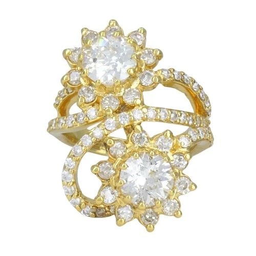 VINTAGE 18K YELLOW GOLD DIAMOND FLORAL BYPASS COCKTAIL RING: VINTAGE 18K YELLOW GOLD DIAMOND FLORAL BYPASS COCKTAIL RING KL TAAO 18k yellow gold diamond floral bypass ring, circa 1990s, designed with a dimensional double flower motif and an arched, curved const