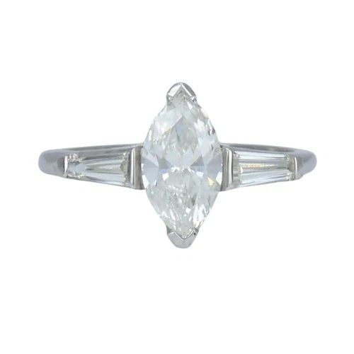 VINTAGE PLATINUM 1.07 CARAT MARQUISE DIAMOND THREE STONE RING: VINTAGE PLATINUM 1.07 CARAT MARQUISE DIAMOND THREE STONE RING KL NGIO Platinum marquise diamond ring, circa 1980s, designed with a 1.07 carat marquise cut center diamond accented by tapered baguette d