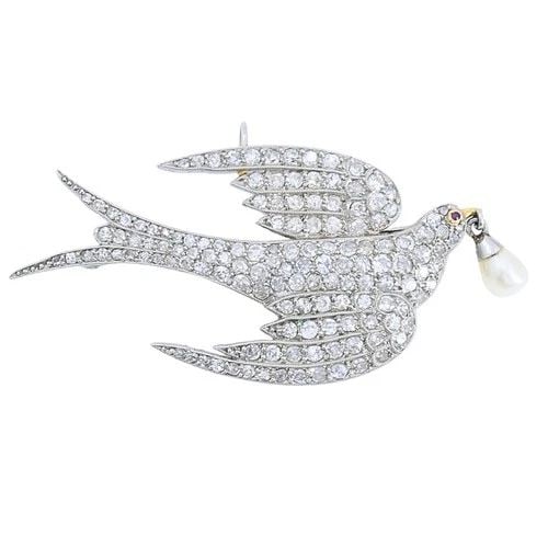 PLATINUM DIAMOND DOVE BROOCH PENDANT WITH PEARL DROP: Platinum Diamond Dove Brooch Pendant with Pearl Drop ES ATOO Product details: CIRCA: 1910s-1920s MATERIALS: Platinum GEMSTONE: Diamond WEIGHT: 7 Grams MEASUREMENTS: 7/8” x 1 3/4” ITEM DETA