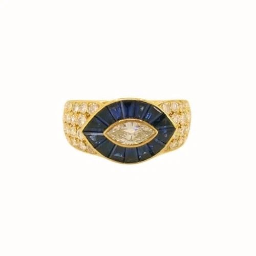 MAUBOUSSIN RING DIAMOND SAPPHIRE 18K GOLD: MAUBOUSSIN RING DIAMOND SAPPHIRE 18K GOLD Mauboussin Ring Diamond Sapphire 18k Gold The ring features a striking eye-shaped motif that plays with symmetry and bold color. At the center is a marquise-c