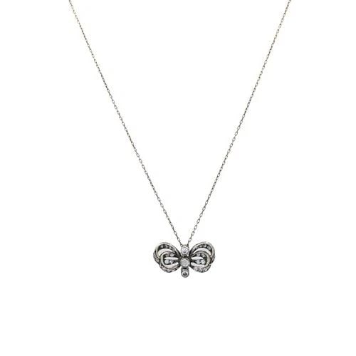 EDWARDIAN STYLE 10K GOLD DIAMOND BOW PENDANT NECKLACE: EDWARDIAN STYLE 10K GOLD DIAMOND BOW PENDANT NECKLACE MATERIALS 10k Gold GEMSTONE Diamond WEIGHT 3.7 Grams MEASUREMENTS The Length 17”; The Pendant - 13/16" x 7/16" ITEM DETAILS Edwardian Style 