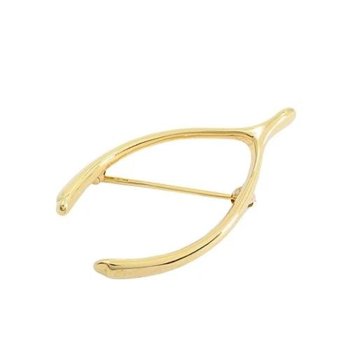 TIFFANY & CO. 14K YELLOW GOLD WISHBONE BROOCH PIN: TIFFANY & CO. 14K YELLOW GOLD WISHBONE BROOCH PIN Designer: Tiffany & Co. Materials: 14K Yellow Gold Weight: 4.2 Grams Measurement: 3/4" x 1 1/2" Hallmarks: 14K, Tiffany ITEM DETAILS: Tiffany & Co. 14