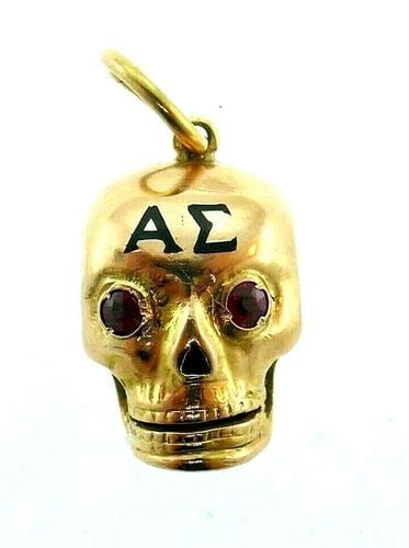 MODERN 18K ROSE GOLD, RUBY & ENAMEL SKULL CHARM ENGRAVED: MODERN 18K ROSE GOLD, RUBY & ENAMEL SKULL CHARM ENGRAVED Modern 18k Rose Gold, Ruby & Enamel Skull Charm This is a must for a collector. The weight is 3 grams. The length is 3/8 of an inch. The height