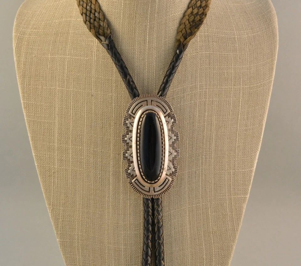 TONEY MITCHELL - LARGE NAVAJO INTRICATE STERLING SILVER WITH ONYX - BOLO TIE: TONEY MITCHELL - LARGE NAVAJO INTRICATE STERLING SILVER WITH ONYX - BOLO TIE This Large vintage bolo tie has been beautifully crafted by Mitchell Toney. He has set a Montana onyx stone into an intrica