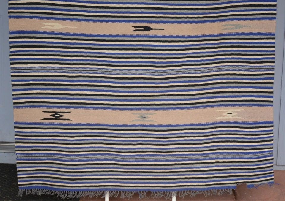 VINTAGE STRIPED RIO GRANDE CHIMAYO BLANKET - BLUES GRAYS TANS - 82" X 50": This vintage Chimayo Rio Grande handwoven striped blanket measures 82" x 50". The colors are blues, grays and tans. Part of one corner is missing.- see close-up photo. And, there are some light dirt s