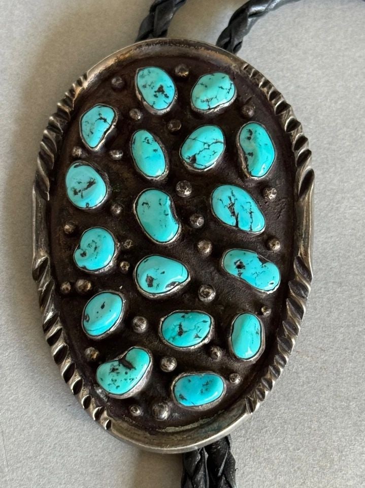 VINTAGE NAVAJO STERLING SILVER AND TURQUOISE BOLO TIE: VINTAGE NAVAJO STERLING SILVER AND TURQUOISE BOLO TIE Vintage Navajo Sterling Silver and Turquoise Bolo Tie With Sterling and Turquoise Tips .. Signed LW ..2 7/8" Tall x 1 7/8" Wide 65 Grams ..Great T